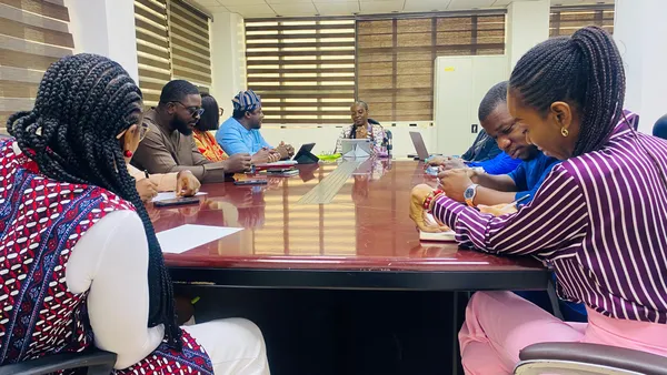 Participants seated together around a meeting table.