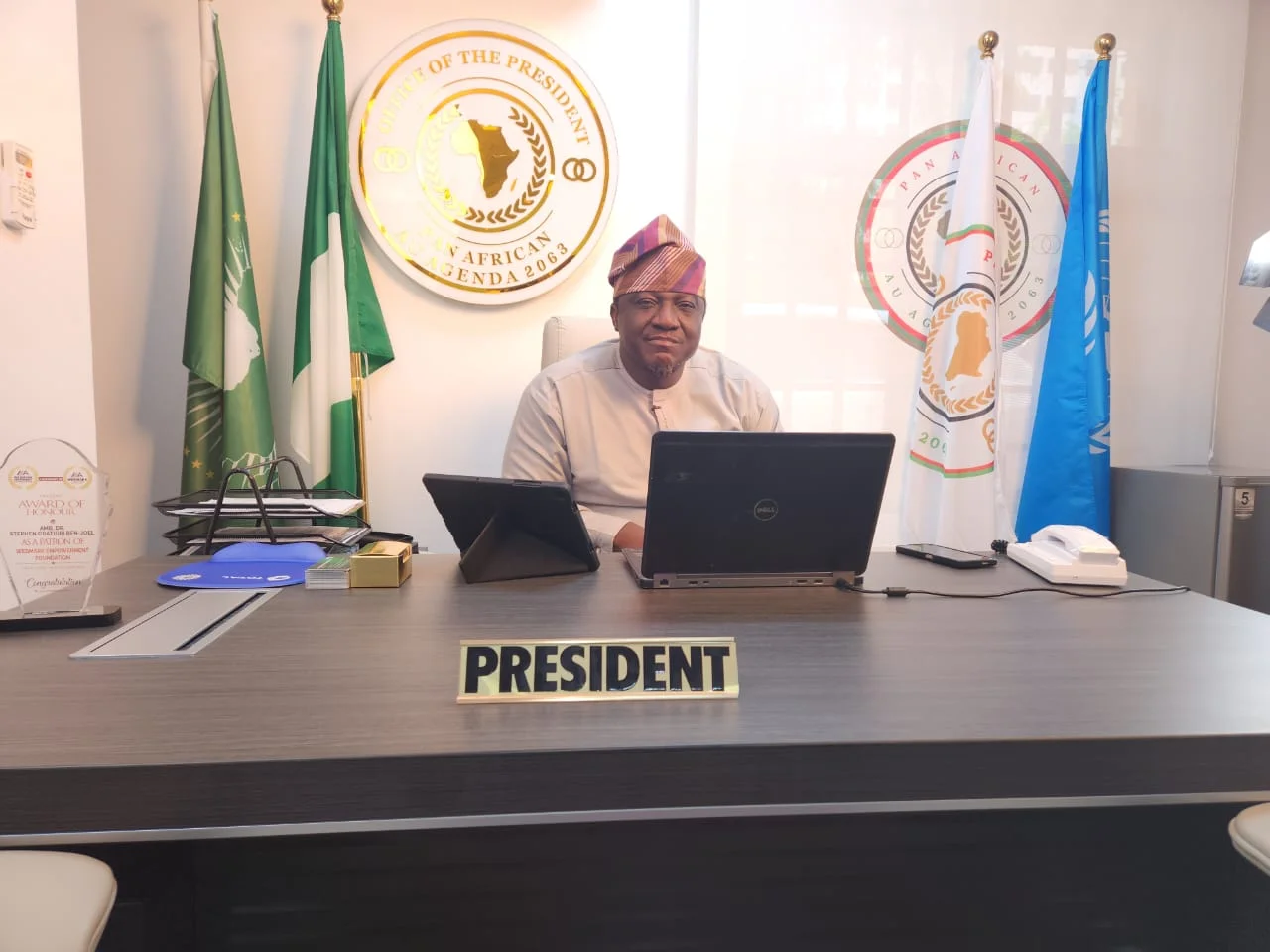 Amb. Dr. Stephen Gbatigbi Ben-Joel seated at his desk in the Office of the President.