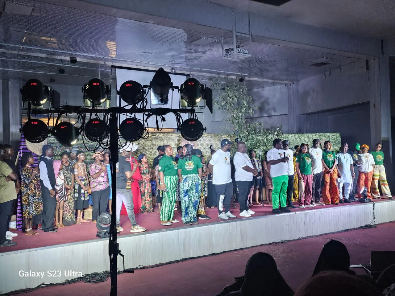 Team members in green PAC-SM shirts photographed together on stage.