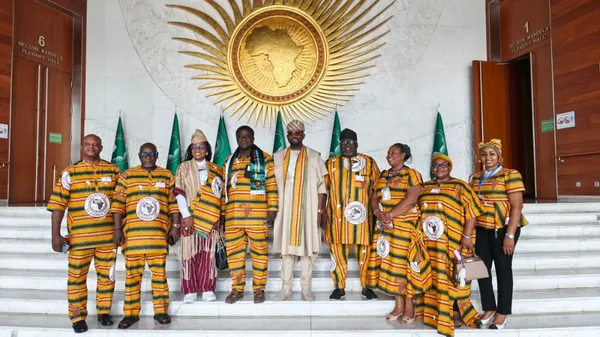 Delegation members photographed on the steps beneath the African Union emblem.